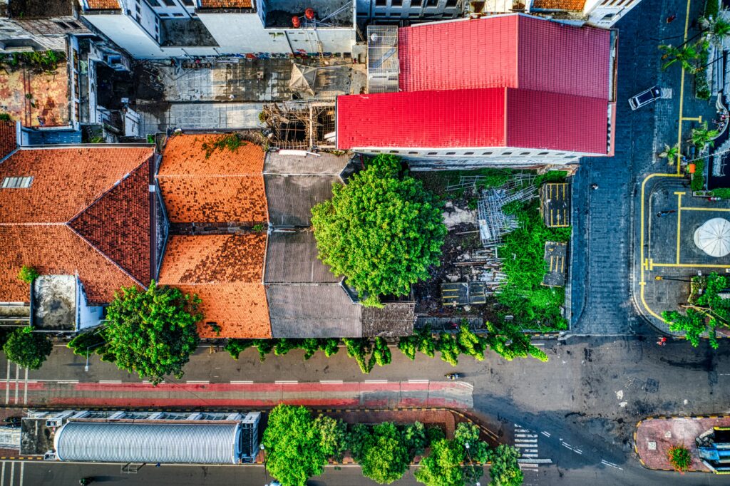 Aerial shot showcasing vibrant rooftops and streets in Jakarta, Indonesia.