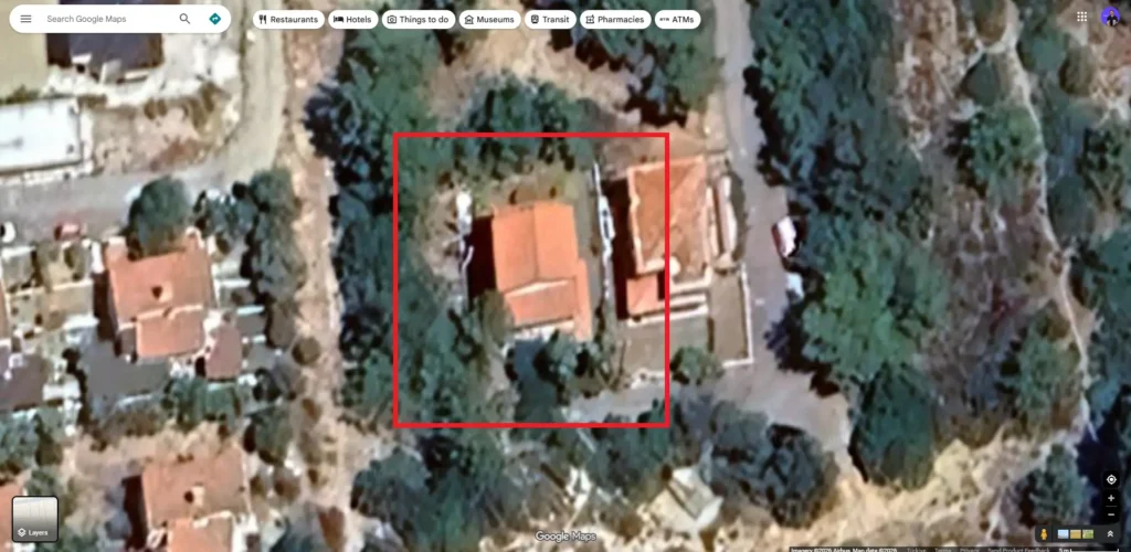 Low-resolution and blurry satellite imagery used for rooftop solar planning, showing unclear roof geometry and hidden shading risks.